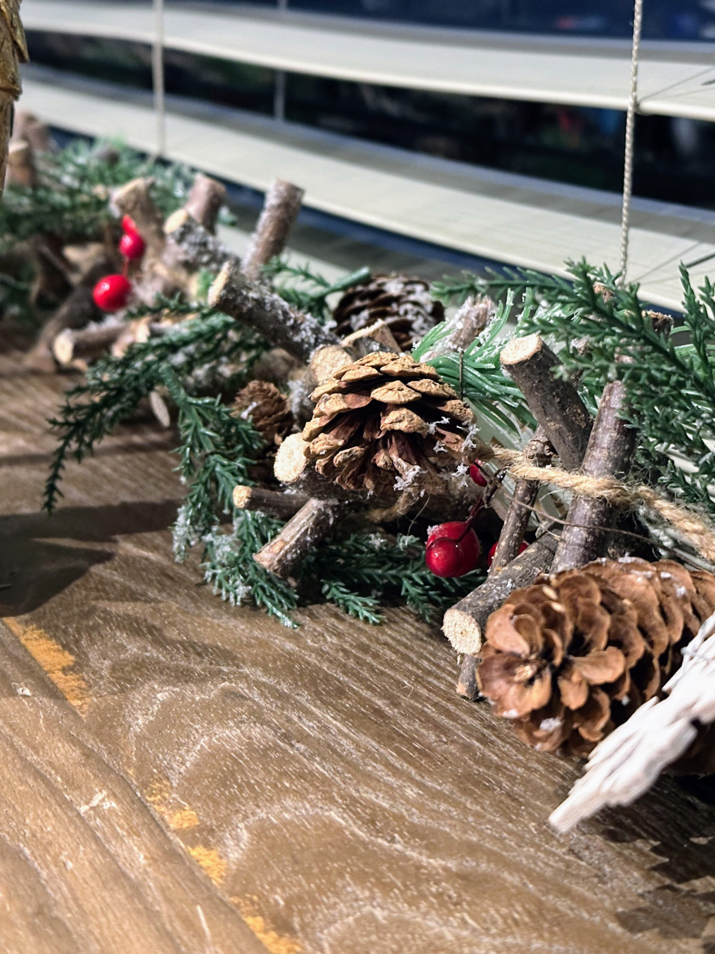 Natural pinecone and evergreen Christmas table decorations at Caravelli