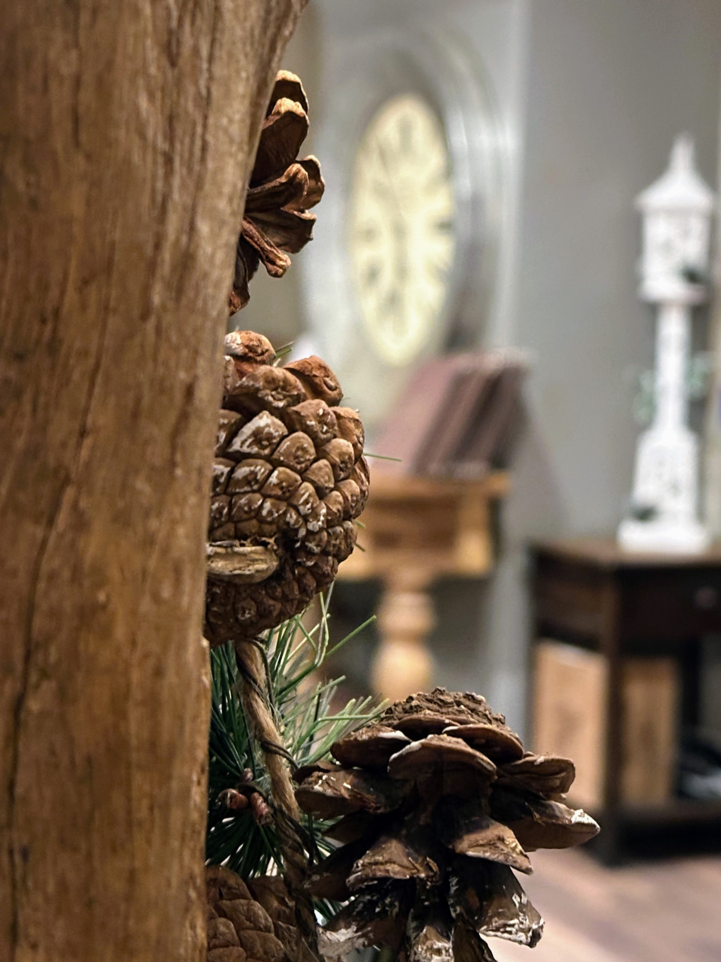 Pinecone Christmas decorations against the Old Manor timber