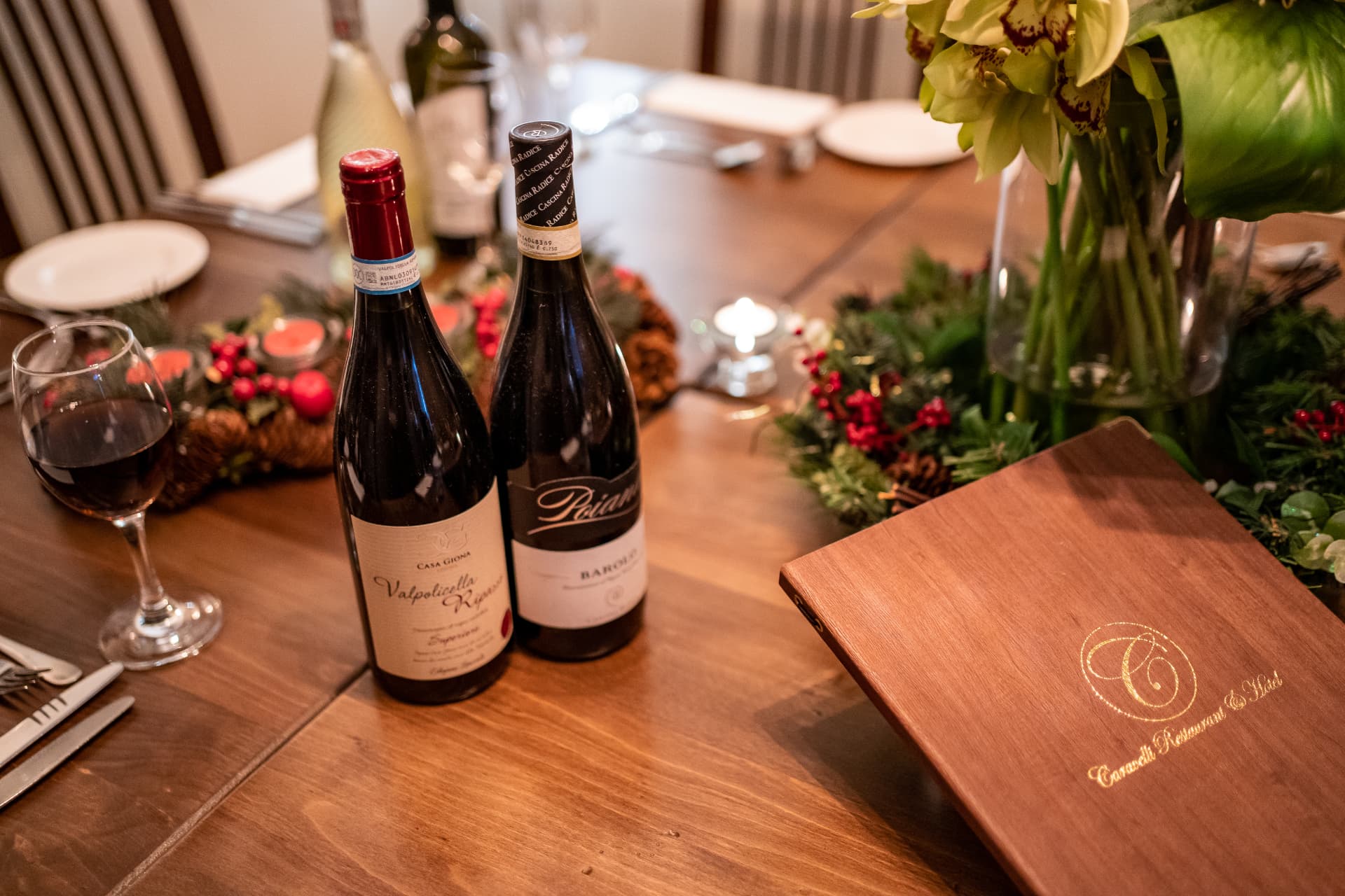Caravelli Christmas table with wine, festive greenery and menus